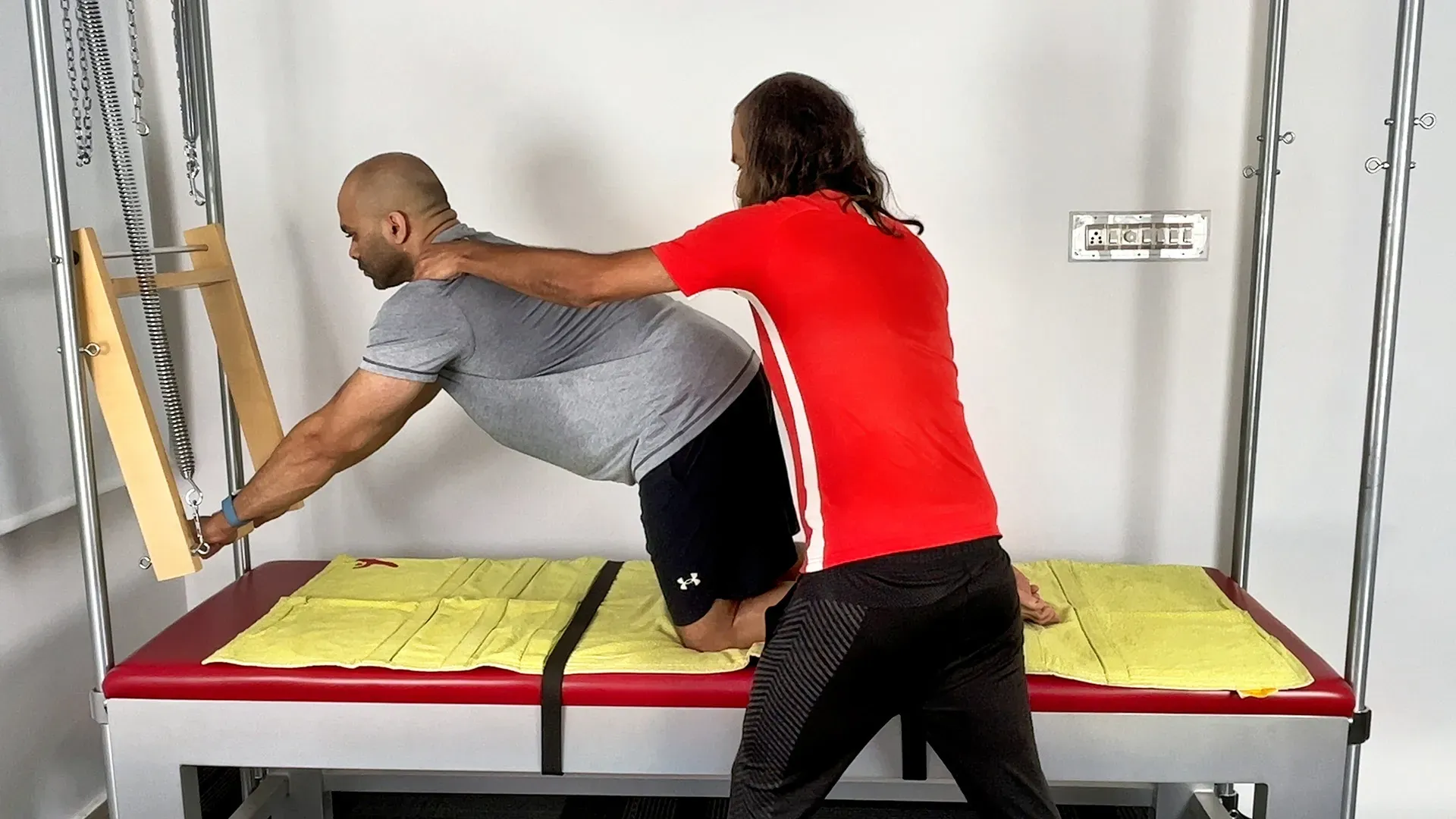Pilates instructor providing movement cue during private lesson in Bengaluru