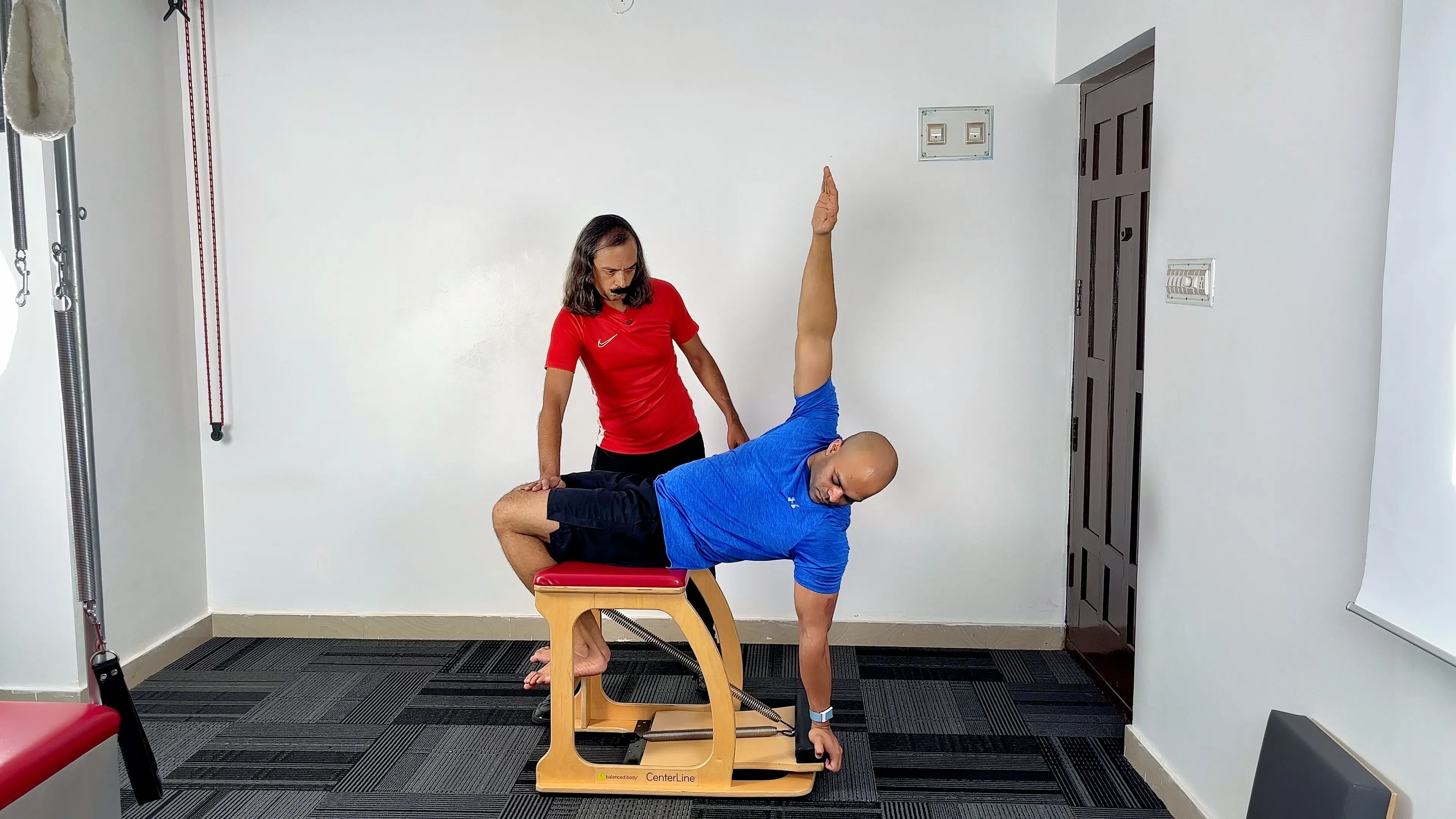 Pilates instruction on traditional apparatus at a private studio in Bengaluru